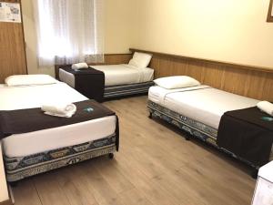 A bed or beds in a room at Angel's Rest Motel