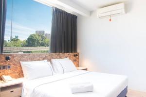 Postel nebo postele na pokoji v ubytování i-Hotel Kuala Lumpur