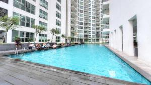 a large swimming pool in the middle of a building at Regalia Upper View Hotel in Kuala Lumpur