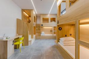 a room with a desk and bunk beds at Kunlun Youth Boutique Hostel in Jilian