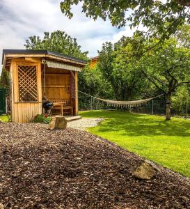 a log cabin with a hammock in a yard at Ferienhaus am Tor zur Wachau in Eggendorf