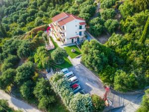 an aerial view of a house with cars parked in a parking lot at Pelagos Agios Gordios in Agios Gordios