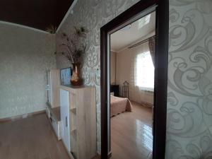 a mirror in a room with a bedroom at Семейные Апартаменты in Pyatigorsk