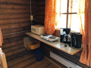 a counter with a microwave and a coffee maker on it at Lane Loge in Uddevalla