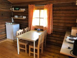 a kitchen with a table and chairs and a window at Lane Loge in Uddevalla