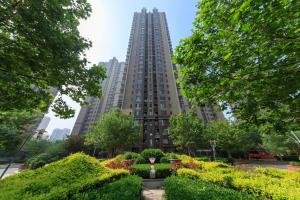 a tall building with a garden in front of it at Tianjin Nankai·Drum tower in Tianjin