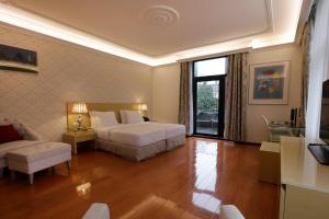 a bedroom with a bed and a living room at Chasse Boutique Hotel in Amsterdam