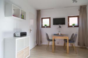 a room with a table and chairs and a television at Ferienwohnung Wieben in Sankt Peter-Ording