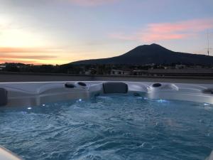 a hot tub with a view of a mountain at Palazzo Marage in Torre del Greco
