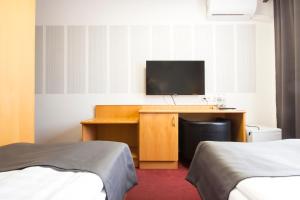Postel nebo postele na pokoji v ubytování Hotel Maroli Mikulov