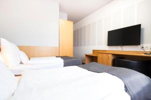 Postel nebo postele na pokoji v ubytování Hotel Maroli Mikulov