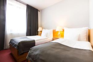 Postel nebo postele na pokoji v ubytování Hotel Maroli Mikulov