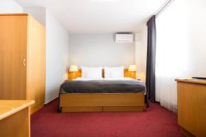 Postel nebo postele na pokoji v ubytování Hotel Maroli Mikulov