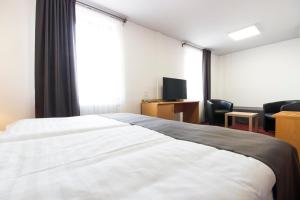 Postel nebo postele na pokoji v ubytování Hotel Maroli Mikulov