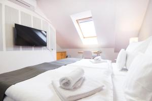Postel nebo postele na pokoji v ubytování Hotel Maroli Mikulov