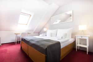 Postel nebo postele na pokoji v ubytování Hotel Maroli Mikulov