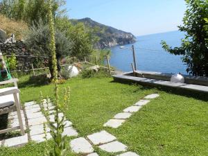 a garden with a view of the water at Corte Del Gallo in Corniglia