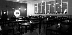 a dining room with tables and chairs in a restaurant at JordaNova in Gołkowice