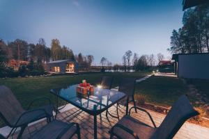 a patio with a table with chairs and a candle at Harmony Place in Olsztyn