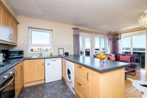 a kitchen with a stove top oven and a sink at Ultra Urban Belfast Corporate Apartments in Belfast