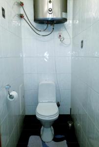 a small bathroom with a toilet and a camera at Отдельная комната с балконом в апартаментах, возле м Печерская in Kyiv