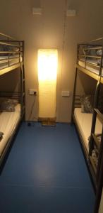 a small room with a bunk bed and a window at The Queens Hostel in London