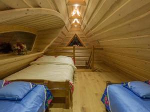 a bedroom with two beds in a log cabin at Chatka pod Giewontem in Ciche
