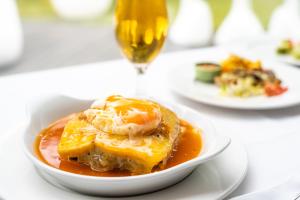 a bowl of food on a table with a drink at HF Ipanema Park in Porto