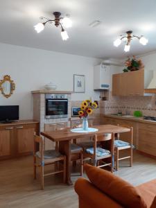 een keuken met een houten tafel met stoelen en een eetkamer bij Agriturismo VILLA MOZART nel verde in Gubbio