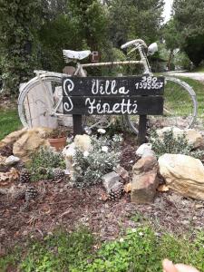 a bike parked next to a sign in a garden at Villa Finetti in Gubbio