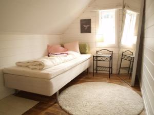 a small room with a couch in a attic at Byrkjeleite - modernized house with 5 bedrooms in Herand