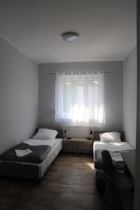 Postel nebo postele na pokoji v ubytování Hotel Sportowy