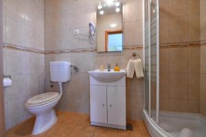 a bathroom with a toilet and a sink and a shower at Apartments Vila Miranda in Vodice +62 photos