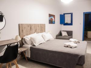a bedroom with a bed with towels on it at Fragoulis Village in Parasporos
