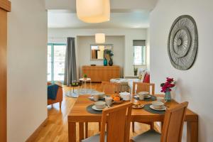 une salle à manger et un salon avec une table et des chaises dans l'établissement Casas Barulho Albufeira Marina, à Albufeira