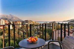 a bowl of fruit on a table on a balcony at Hotel Bono in Budva