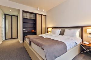 a large bedroom with a large bed and a desk at Hotel Bono in Budva