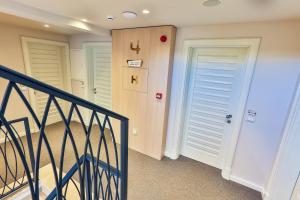a hallway with two doors and a stairway at Hotel Bono in Budva