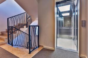 a hallway with a staircase and a glass door at Hotel Bono in Budva