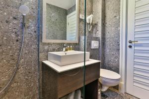 a bathroom with a sink and a toilet and a shower at Hotel Bono in Budva