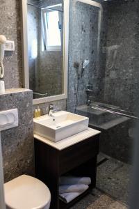 a bathroom with a sink and a shower at Hotel Bono in Budva