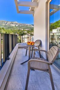 a balcony with a table and chairs on a balcony at Hotel Bono in Budva