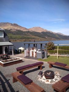 a picnic area with benches and a fire place at THE ANCHORAGE in Arrochar
