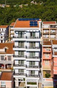 an aerial view of a white building with balconies at Hotel Bono in Budva