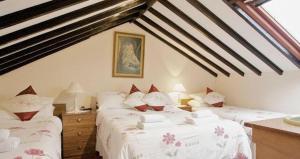 a bedroom with two beds in a attic at Fjaerland Hotel in Great Yarmouth