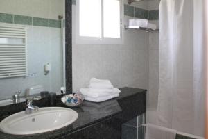 a bathroom with a sink and a mirror at Chrielka Hotel in Limassol