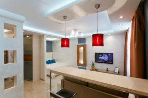 a kitchen with red lights in a room at Minsklux Apartment 2 in Minsk