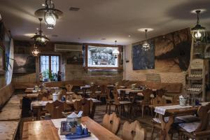 a restaurant with wooden tables and wooden chairs at Penzion Sklípek in Staré Splavy