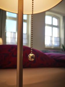 a close up of a lamp with a chain attached to it at Strada Giardino Tangermünde in Tangermünde