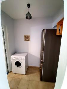 a kitchen with a refrigerator and a washing machine at Nefeli in Livadi